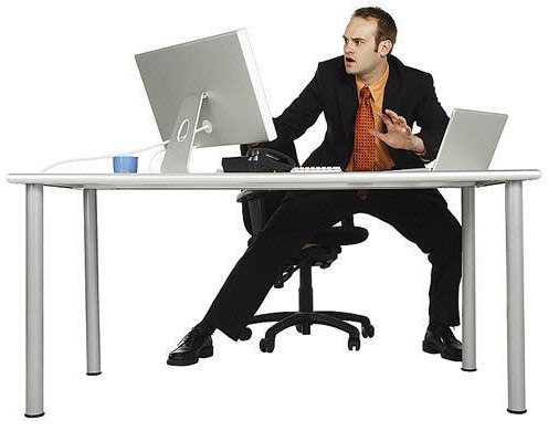 Man next to iMac looking rather shocked